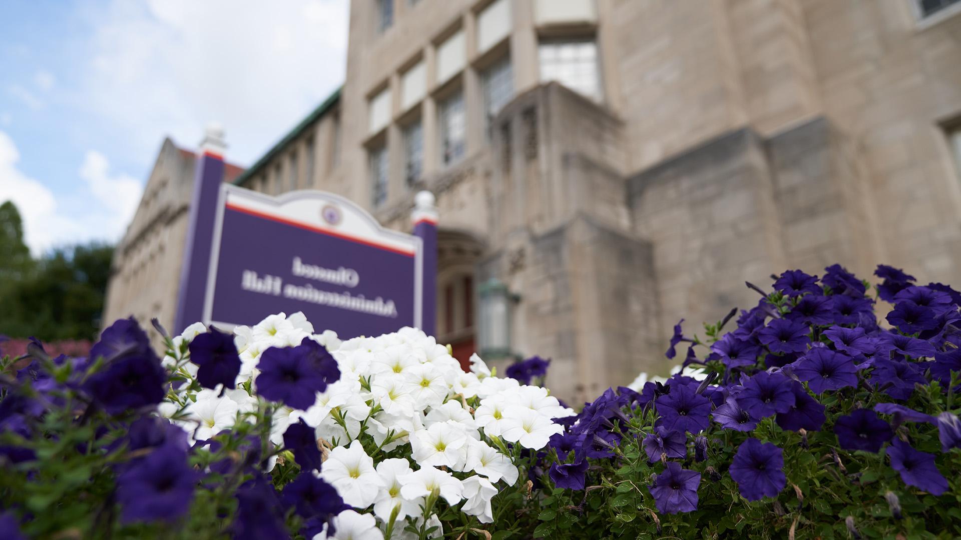 Olmsted sign with flowers in summer